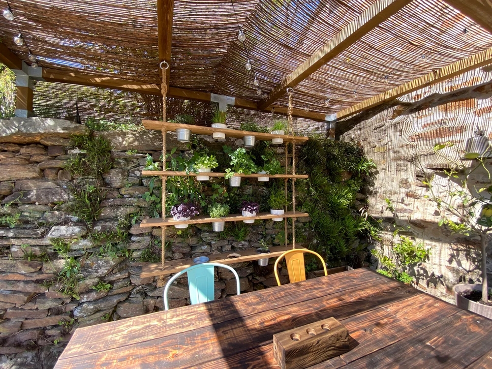 jardines colgantes hechos con estantes de madera y cuerda, ideales para cultivar hierbas aromáticas en patios o terrazas